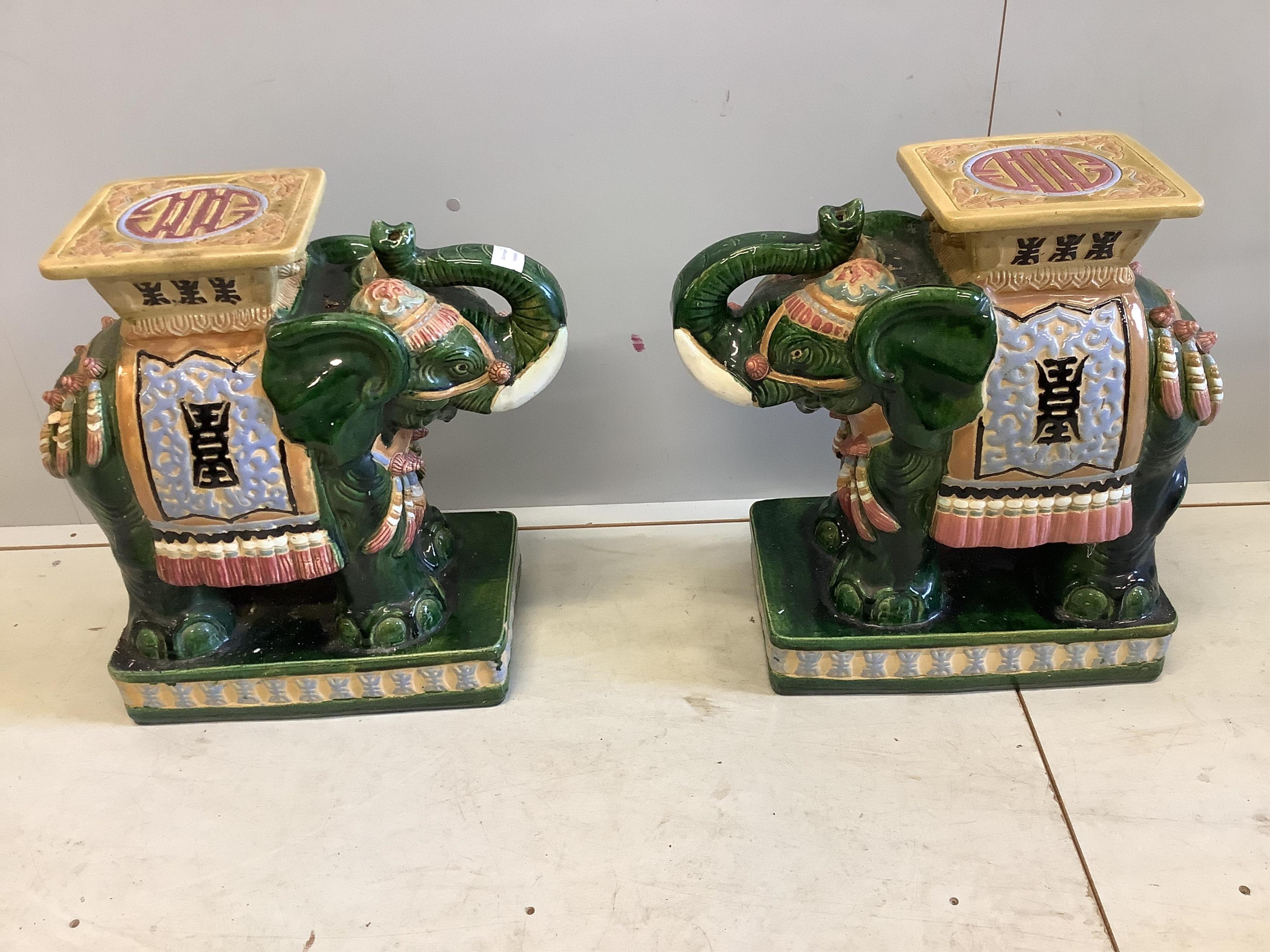 A pair of Chinese glazed earthenware elephant and howdah jardiniere stands, width 26cm, depth 44cm, height 56cm. Condition - fair